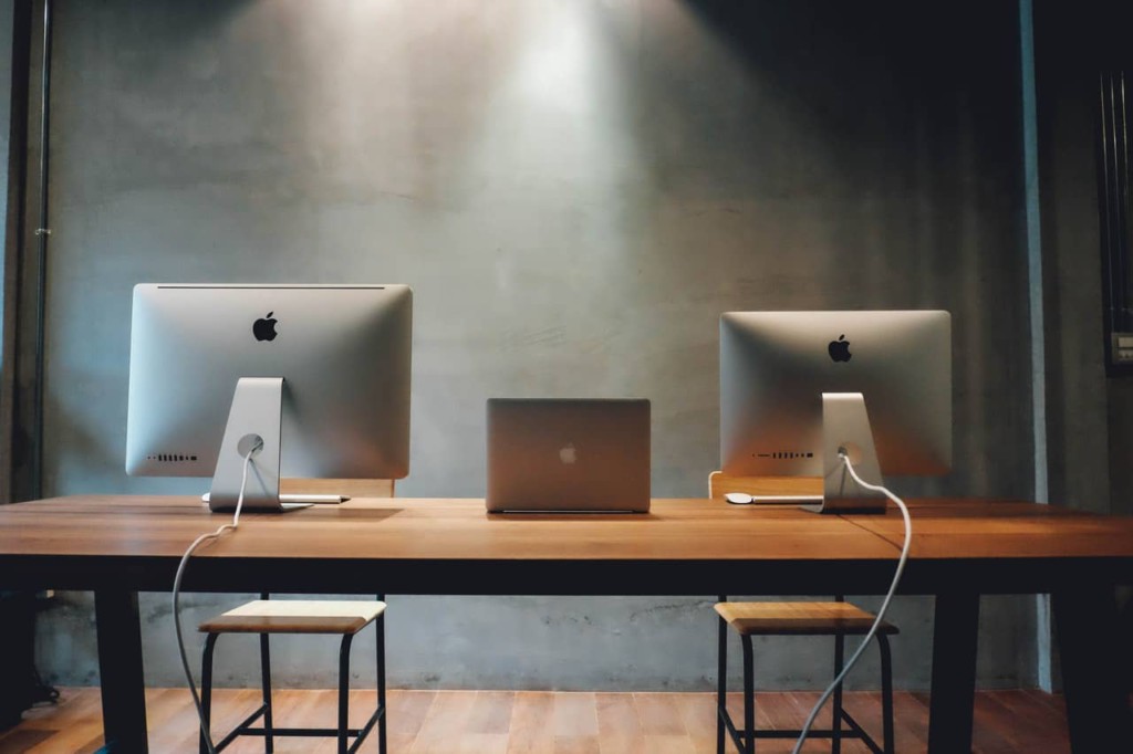 work desktops and laptops on a desk